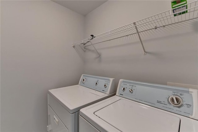 clothes washing area with laundry area and washer and clothes dryer