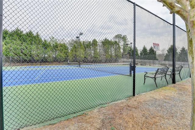 view of tennis court with fence