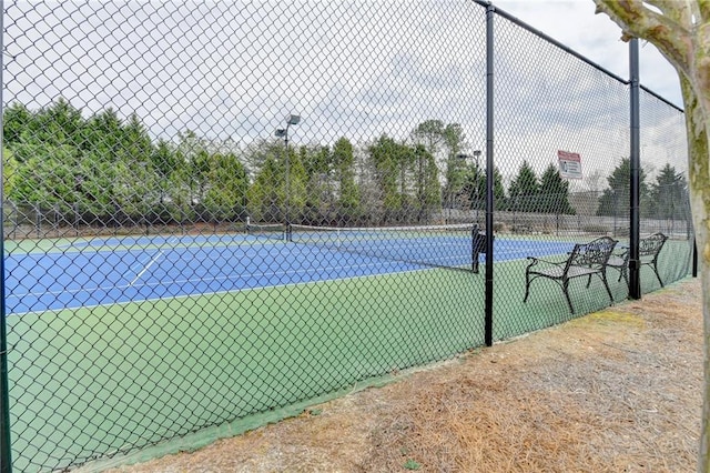 view of tennis court with fence