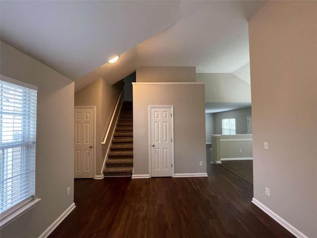 interior space with lofted ceiling and dark wood-type flooring