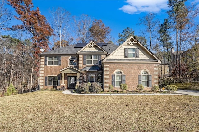 view of front of property with solar panels and a front lawn