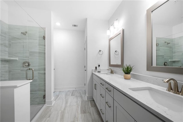 bathroom with vanity and a shower with shower door