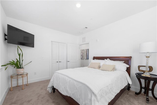 carpeted bedroom featuring a closet