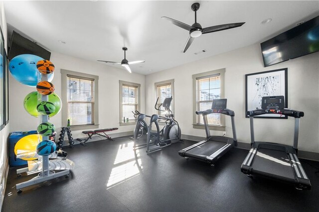 workout area featuring ceiling fan and plenty of natural light