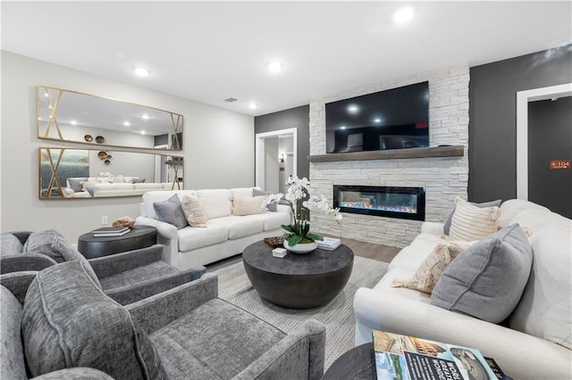 living room featuring a fireplace and wood-type flooring