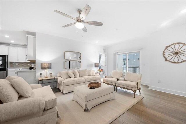 living room with ceiling fan and light hardwood / wood-style floors