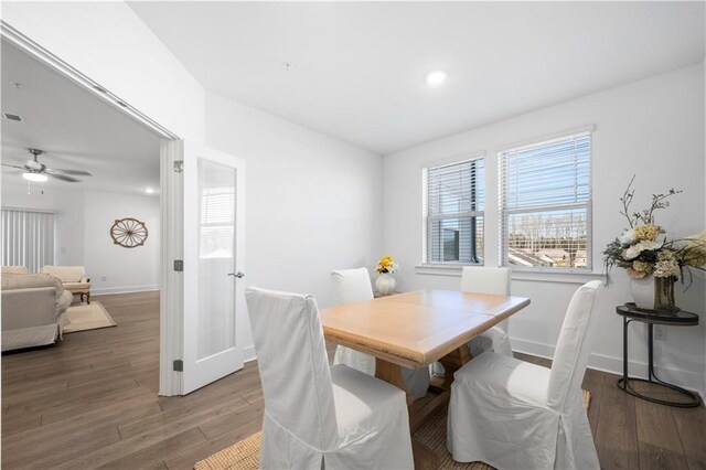 dining area with ceiling fan and wood-type flooring