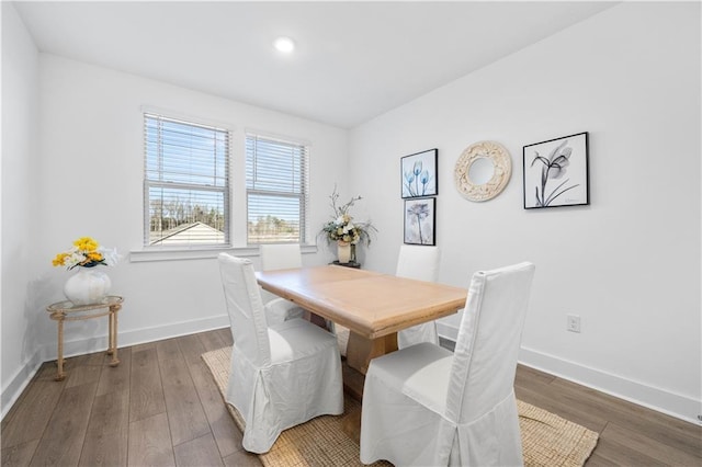 dining space with dark hardwood / wood-style flooring