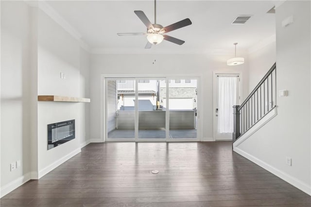 671 Stickley Oak Way, Woodstock, GA 30189 - unfurnished living room featuring ornamental molding, hardwood / wood-style floors, ceiling fan, a glass covered fireplace, and stairway