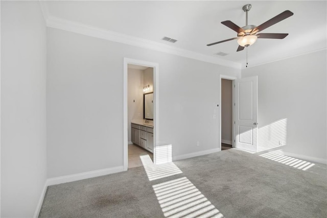 unfurnished bedroom featuring ceiling fan, crown molding, light carpet, and ensuite bathroom