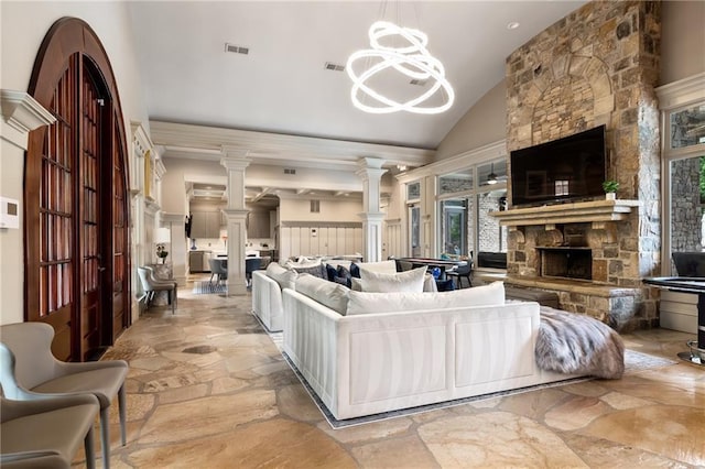 671 Stickley Oak Way, Woodstock, GA 30189 - living room with stone floors, lofted ceiling, a fireplace, decorative columns, and a chandelier