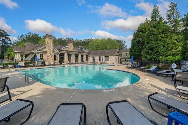 671 Stickley Oak Way, Woodstock, GA 30189 - community pool featuring a patio
