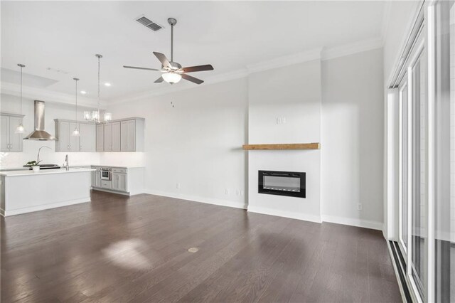 unfurnished living room with ceiling fan and dark hardwood / wood-style floors