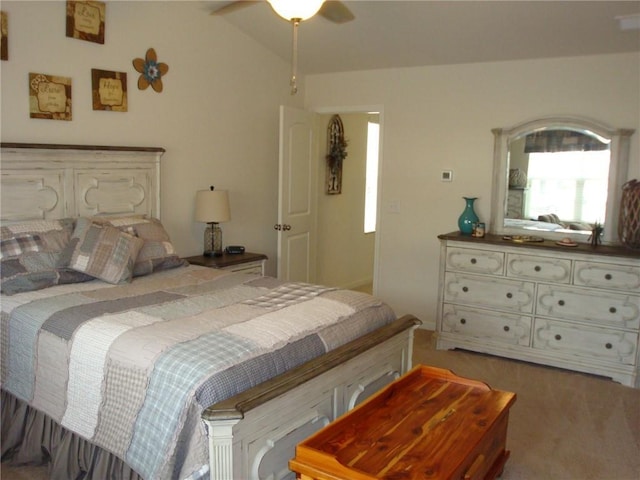 carpeted bedroom featuring lofted ceiling and ceiling fan