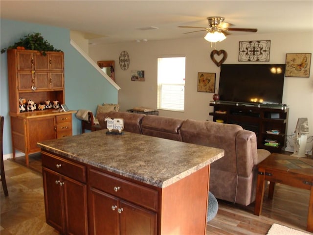 kitchen featuring ceiling fan and a center island