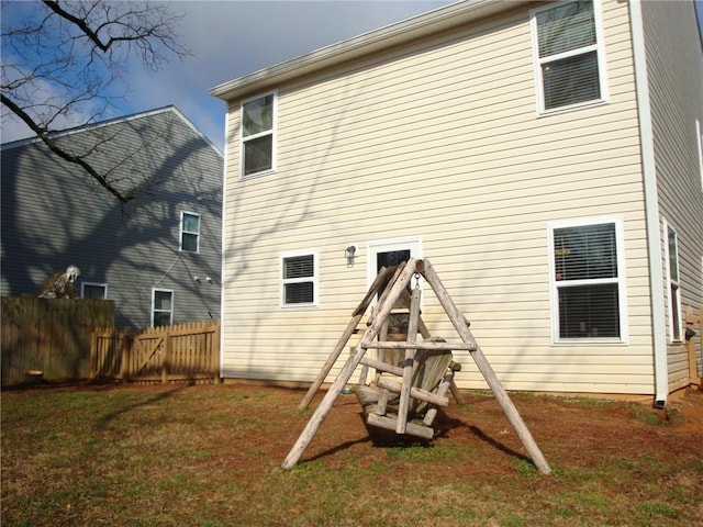 back of property featuring a yard