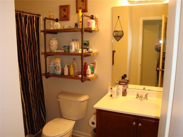 bathroom with vanity, a shower with curtain, and toilet