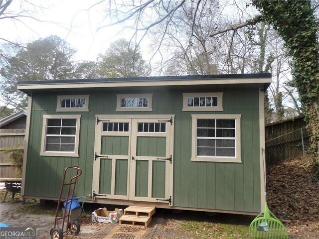 view of shed with fence