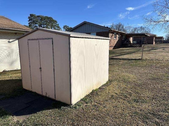 view of shed with fence