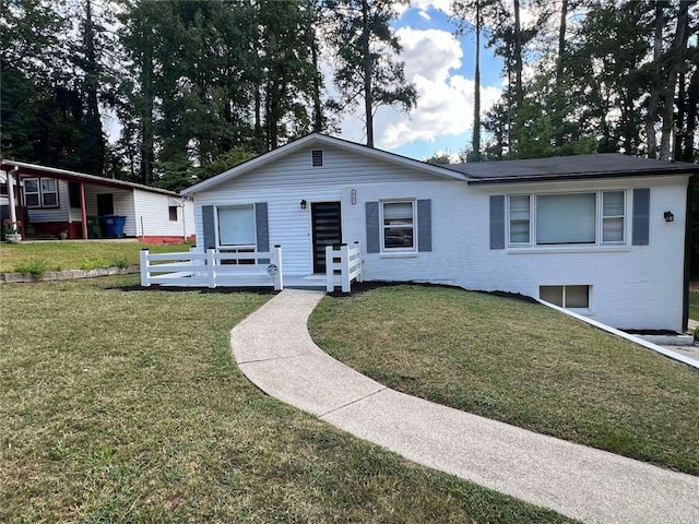 view of front of home with a front yard and a wooden deck