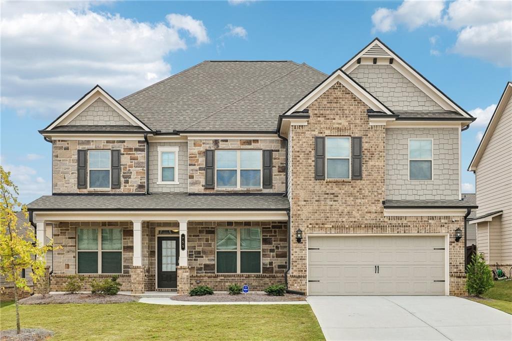 craftsman-style home with a garage and a front lawn