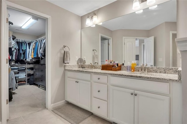 416 Montclair Ct, Woodstock, GA 30188 - bathroom featuring double vanity, a walk in closet, and tile patterned flooring