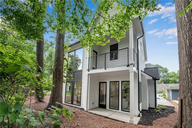 back of property featuring a balcony