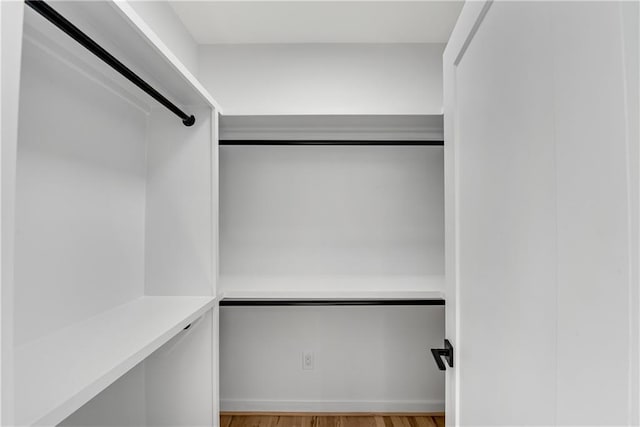 spacious closet with light hardwood / wood-style floors