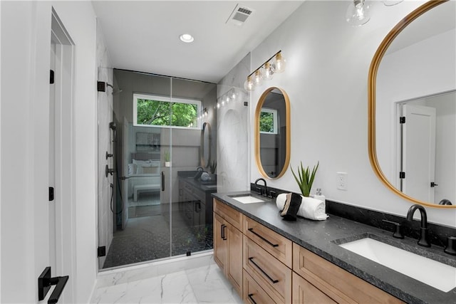 bathroom with vanity and a shower with door