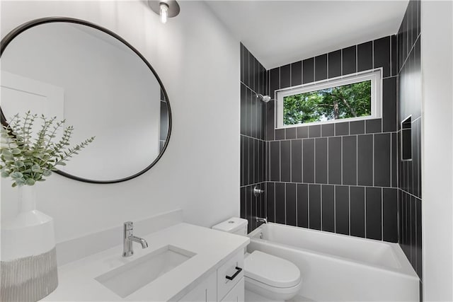 full bathroom with vanity, toilet, and tiled shower / bath