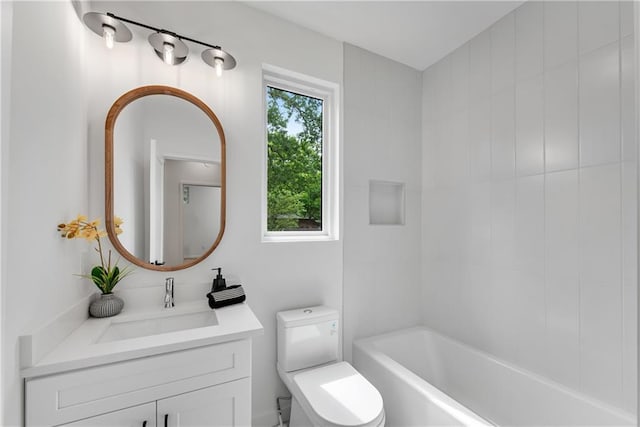 bathroom with vanity, a healthy amount of sunlight, toilet, and a tub