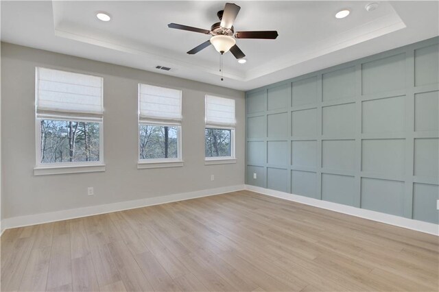 kitchen featuring stainless steel appliances, light wood-style flooring, a sink, gray cabinets, and under cabinet range hood