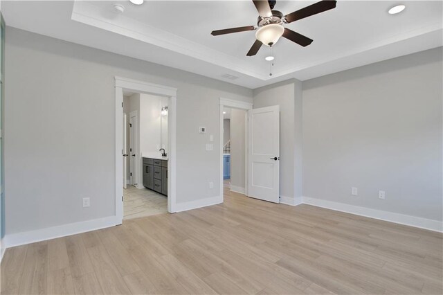 kitchen featuring light wood-style floors, gray cabinetry, light countertops, under cabinet range hood, and appliances with stainless steel finishes