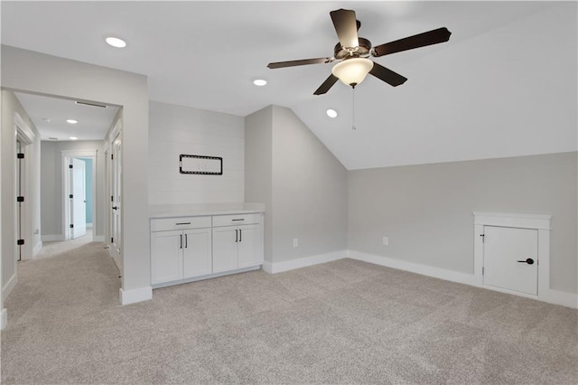 additional living space with vaulted ceiling, ceiling fan, light carpet, baseboards, and recessed lighting