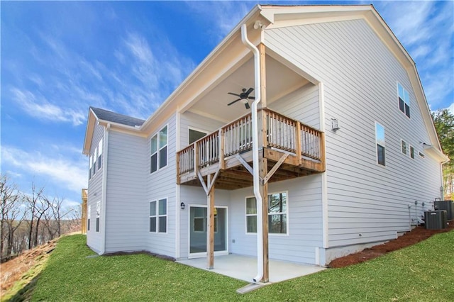 back of house featuring central AC unit, a patio area, a lawn, ceiling fan, and a deck