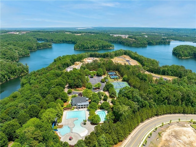 bird's eye view featuring a wooded view and a water view