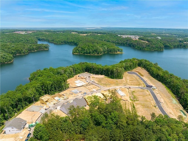 aerial view with a forest view and a water view