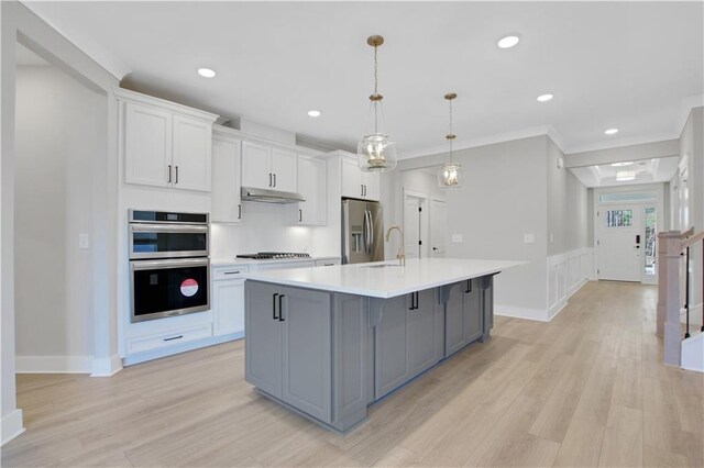 unfurnished bedroom with baseboards, recessed lighting, light wood finished floors, and a raised ceiling
