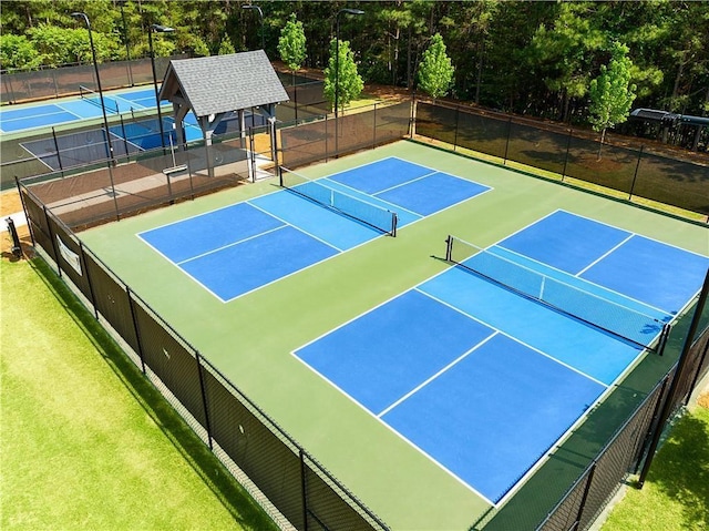 view of sport court featuring fence