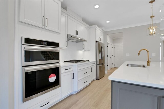 full bath with double vanity, a spacious closet, marble finish floor, and a sink