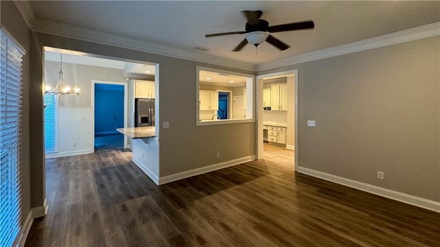 empty room with ornamental molding, ceiling fan with notable chandelier, and dark wood-type flooring