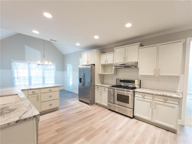 kitchen with stainless steel appliances, lofted ceiling, decorative light fixtures, decorative backsplash, and white cabinets