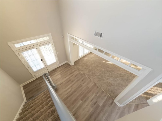 unfurnished living room featuring a high ceiling and dark wood-type flooring