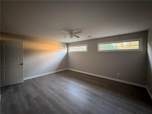 spare room with ceiling fan and dark wood-type flooring