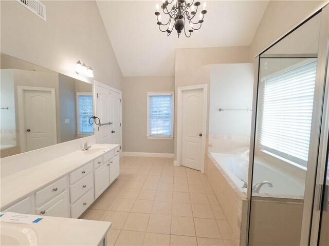 bathroom featuring vanity, plenty of natural light, and lofted ceiling