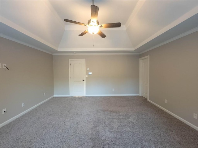 empty room featuring carpet flooring, ceiling fan, a raised ceiling, and ornamental molding