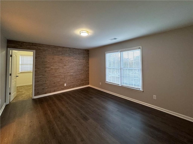 spare room featuring dark wood-type flooring