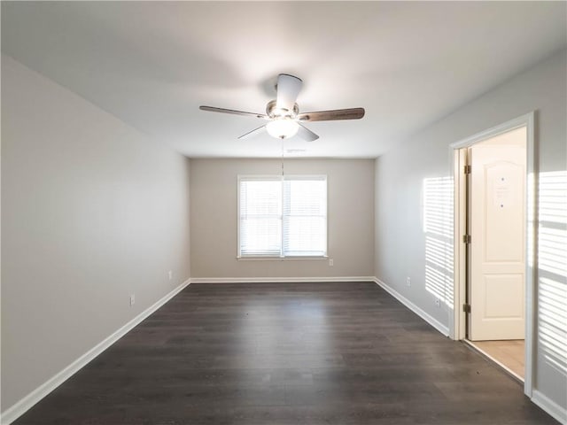 spare room featuring ceiling fan and dark wood-type flooring