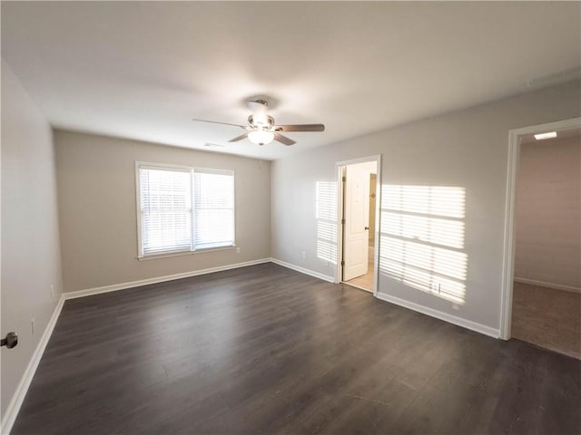 spare room with ceiling fan and dark hardwood / wood-style flooring