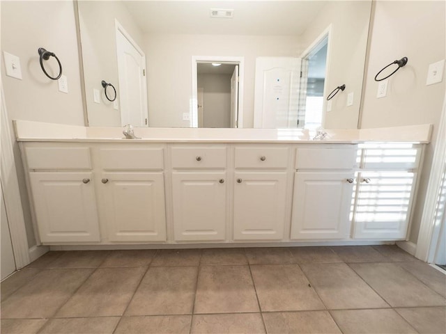 bathroom with tile patterned flooring and vanity